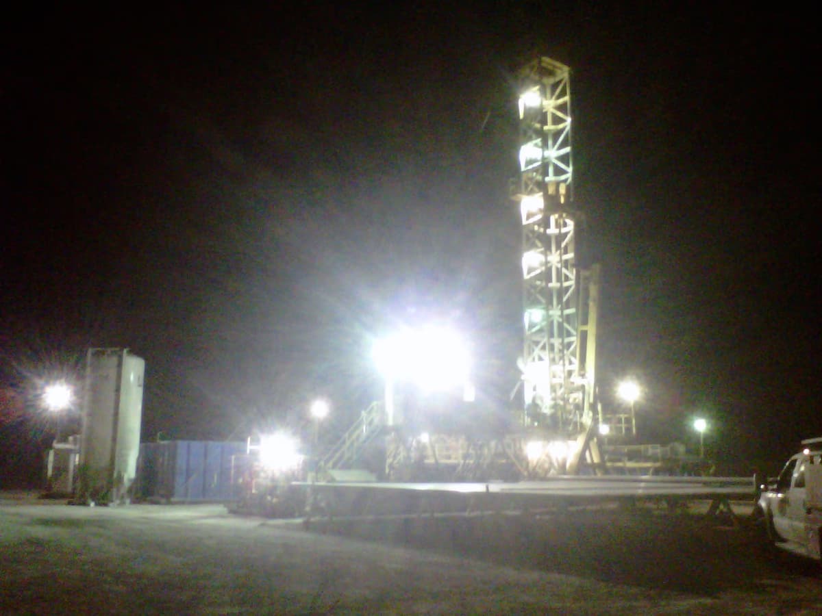 Active Permian Basin drilling rig tower in West Texas oil field