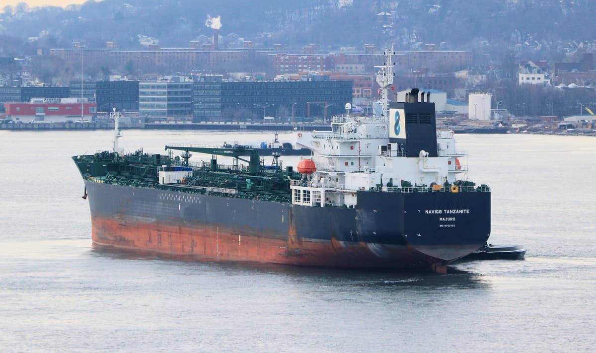 Large oil tanker sailing through open harbour waters on a clear day