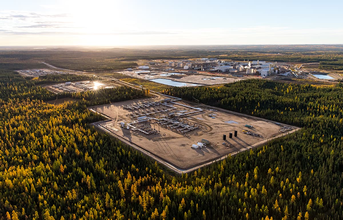 Aerial view of Christina Lake North SAGD oil sands facility surrounded by Alberta boreal forest at sunrise