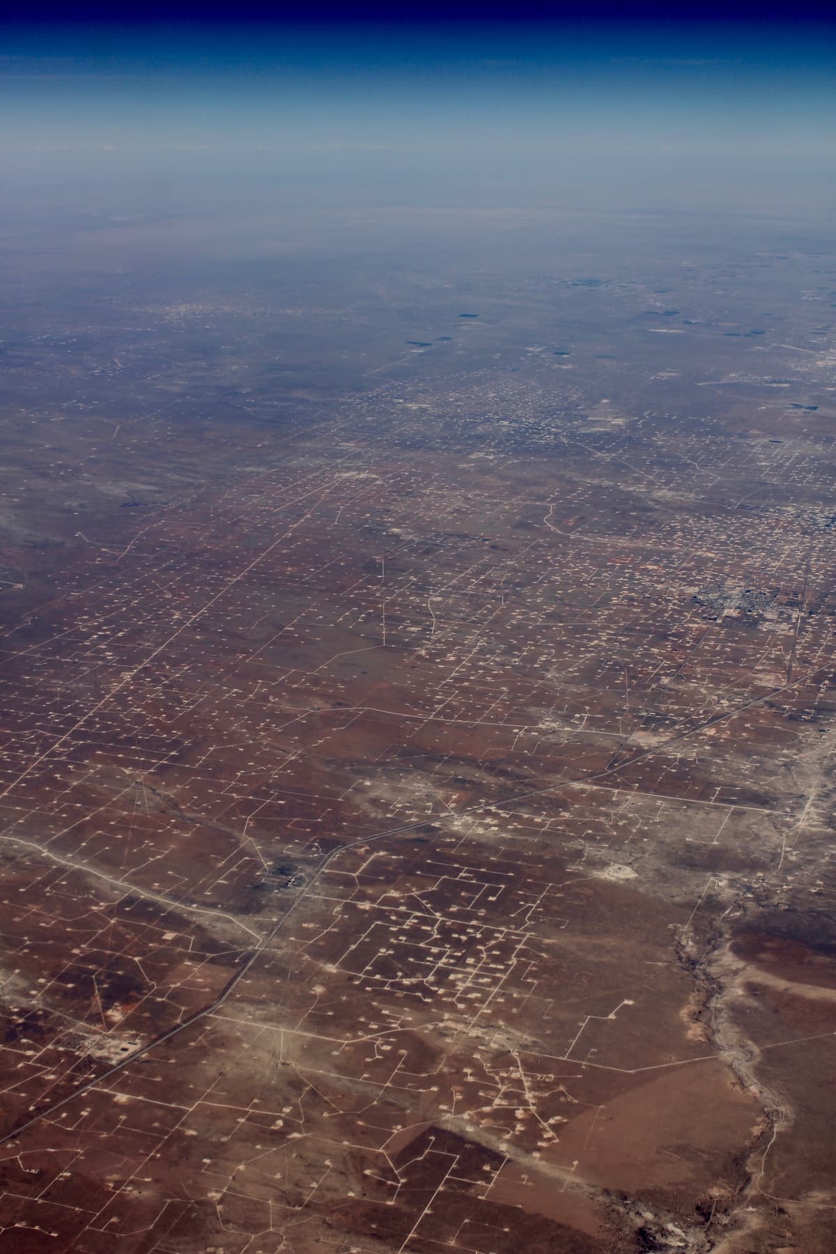Aerial view of oil production operations in West Texas Permian Basin oilfields near Midland