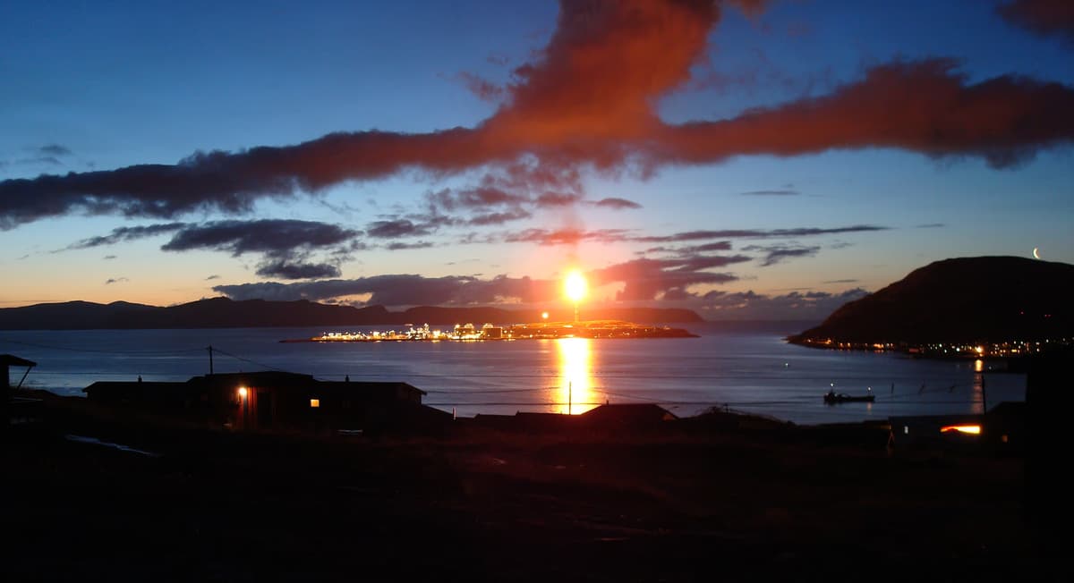 Hammerfest LNG plant on Melkøya island in Norway at dusk with gas flare