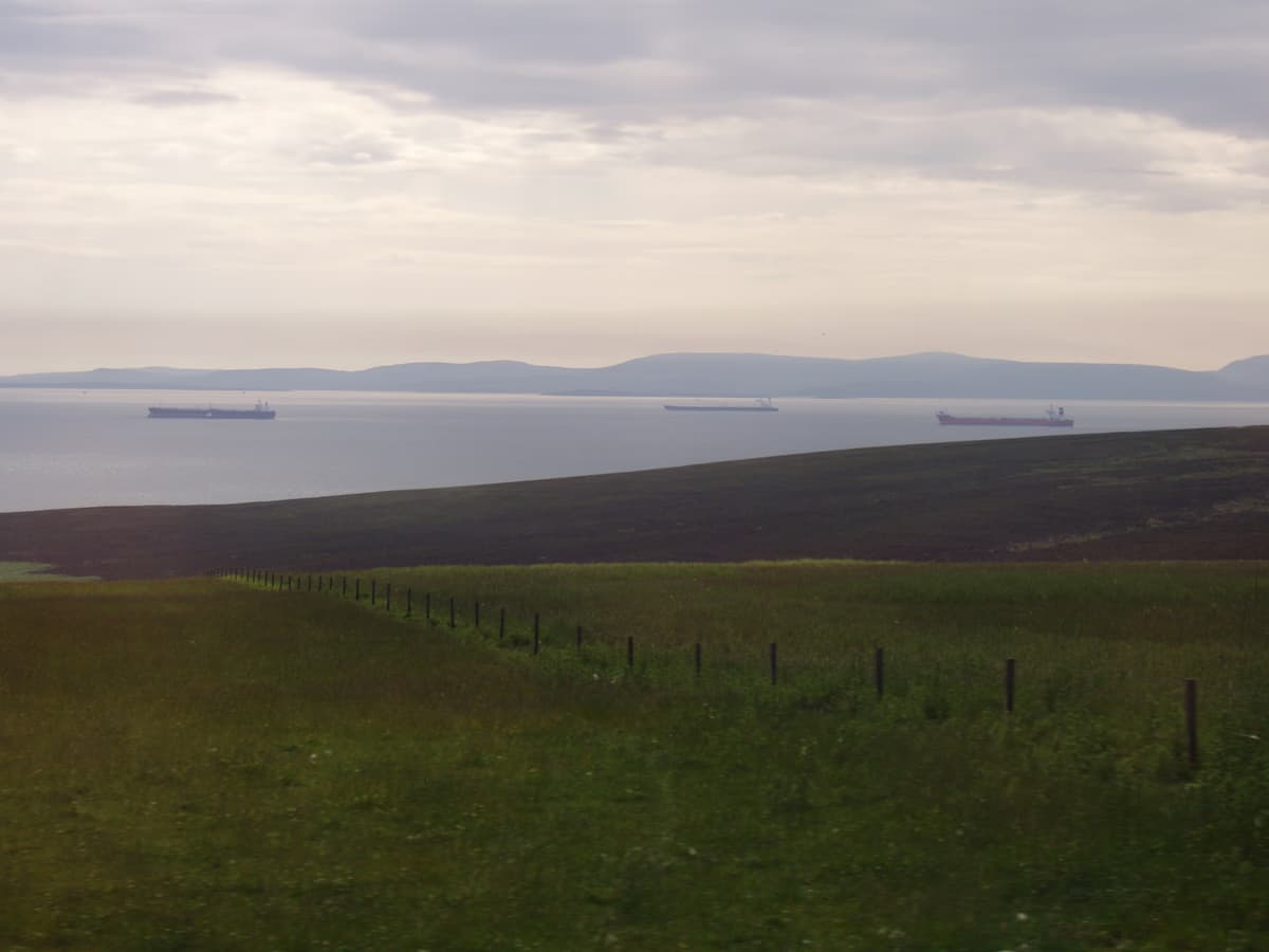 Multiple petroleum tankers waiting at anchor in calm waters, Scapa Flow Orkney Islands