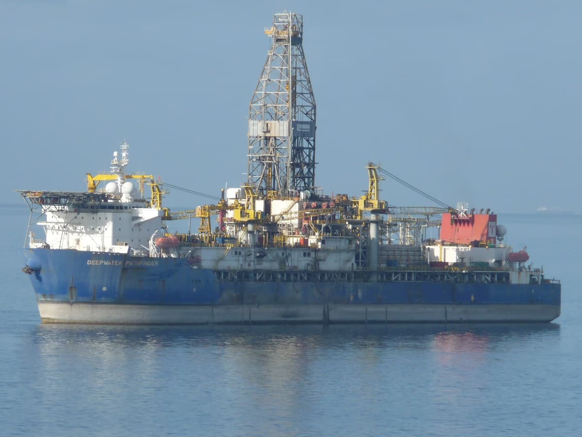 Transocean Deepwater Pathfinder drillship at sea in daylight with drill derrick visible