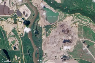 Aerial view of Athabasca oil sands mining operations in northeastern Alberta showing the scale of surface extraction