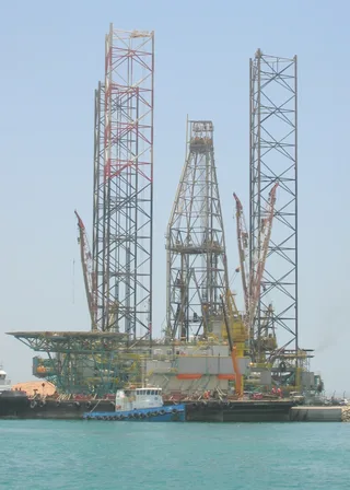 Jack-up drilling rig docked in Abu Dhabi port at Mena Zayed in the United Arab Emirates