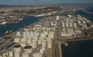 Aerial photograph of large cylindrical petroleum storage tanks at the Port of Barcelona, Spain