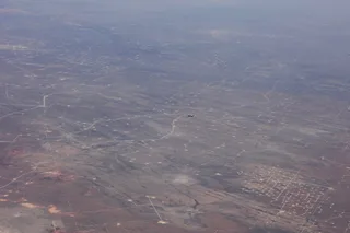 Aerial photograph of oil field operations across Texas with pump jacks and drilling infrastructure