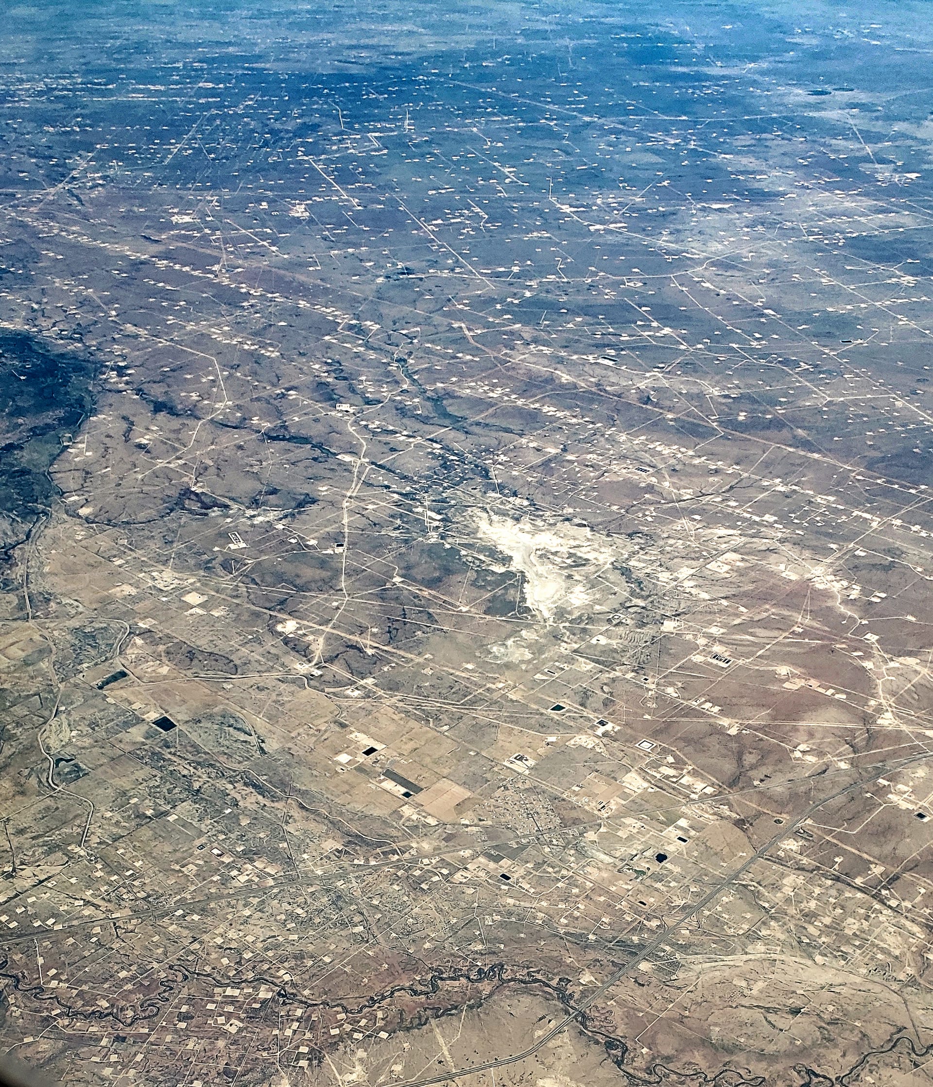Aerial view of Permian Basin oil fields in Ward County, Texas showing active production sites