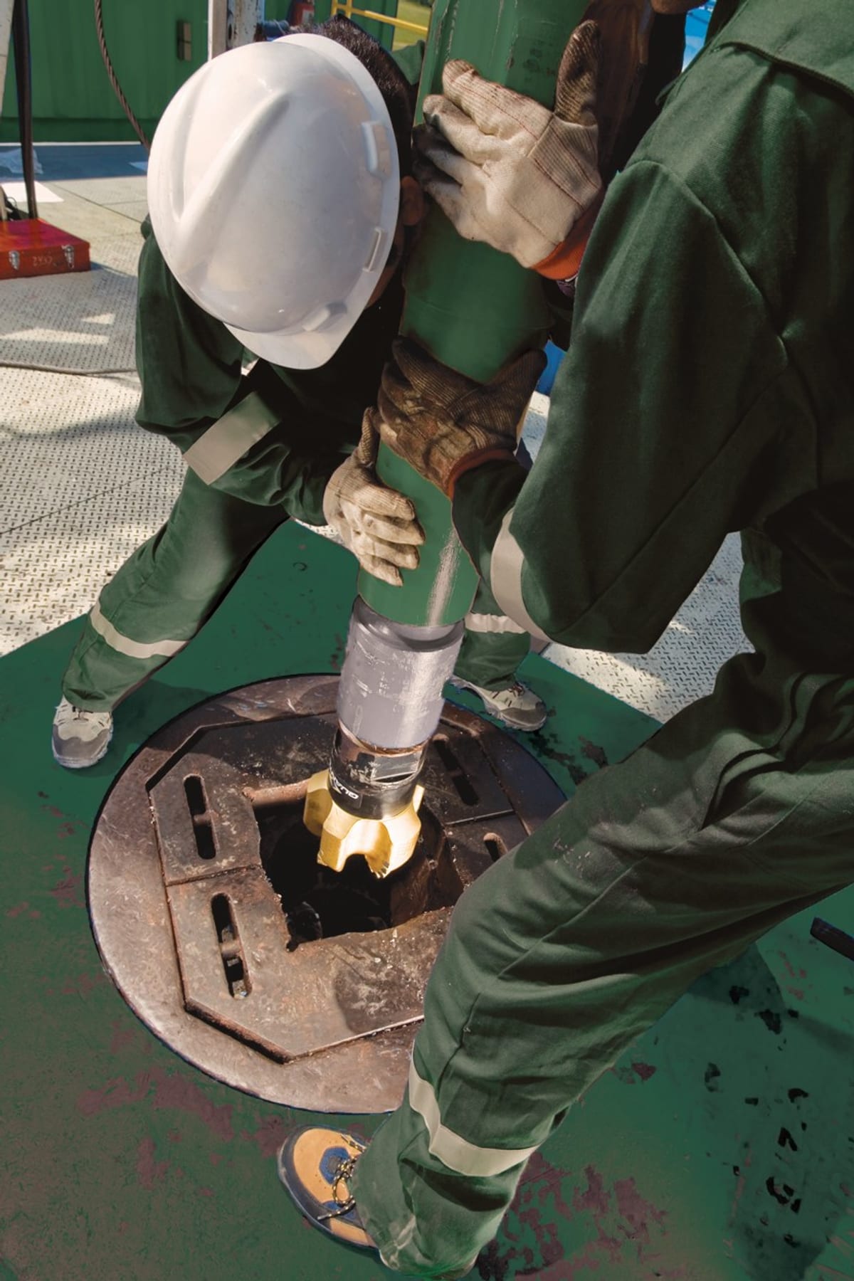 Baker Hughes field workers operating on a drilling floor rig at a North American shale wellsite