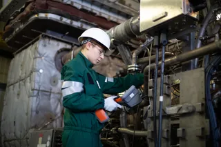 Baker Hughes field service engineer working on a NovaLT gas turbine at an onshore energy facility