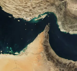 Satellite view of the Strait of Hormuz waterway between Iran and Oman with shipping lanes visible
