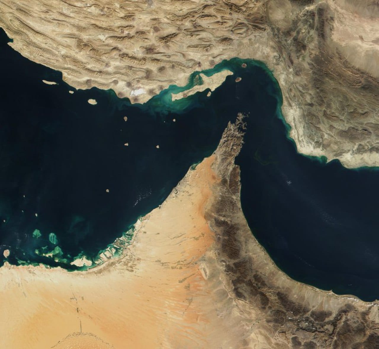 Satellite view of the Strait of Hormuz waterway between Iran and Oman with shipping lanes visible