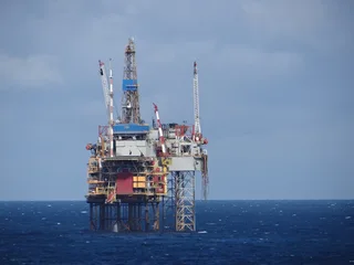 Offshore oil and gas production platform operating in the North Sea with platform infrastructure and ocean below