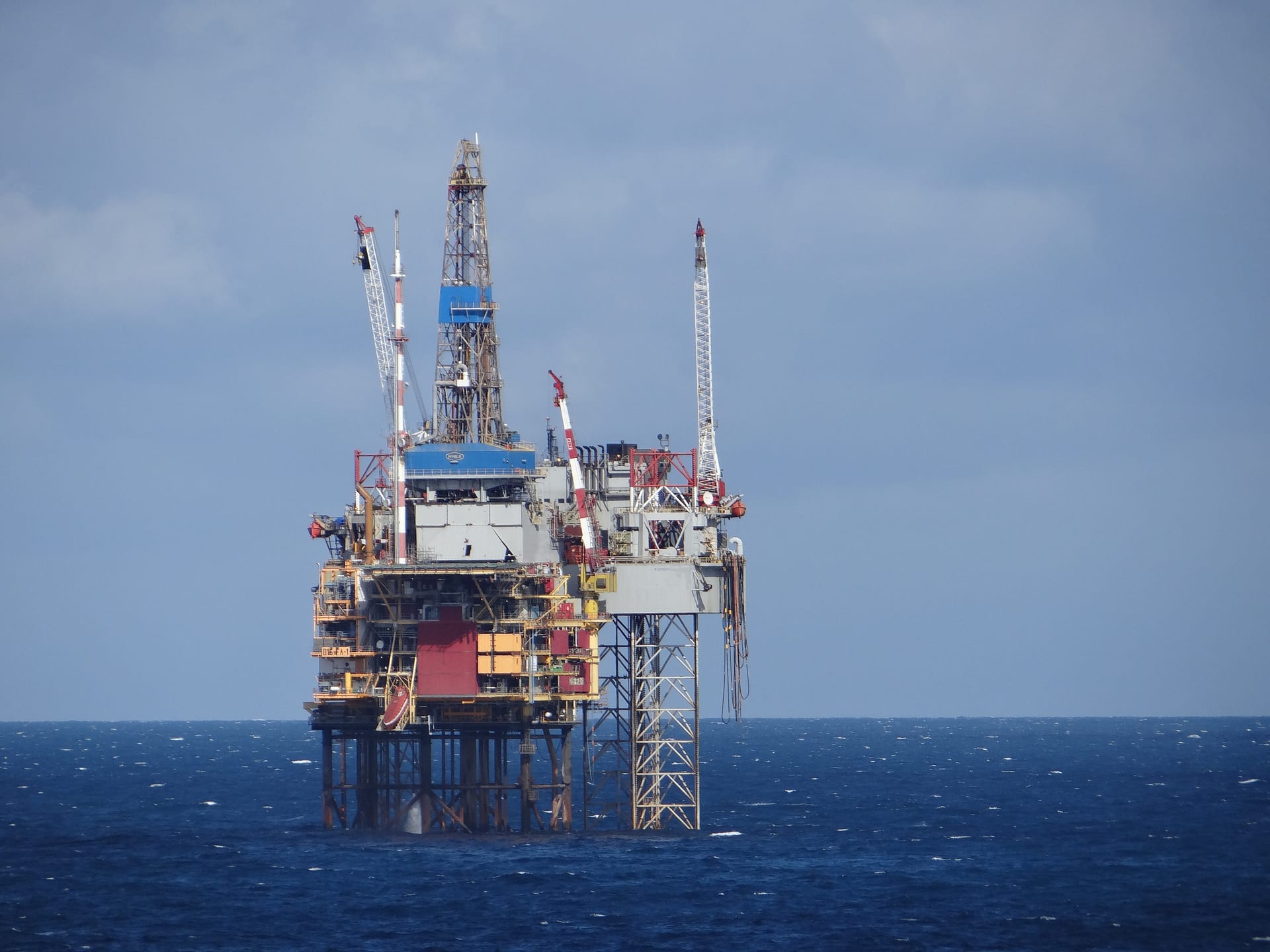 Offshore oil and gas production platform operating in the North Sea with platform infrastructure and ocean below