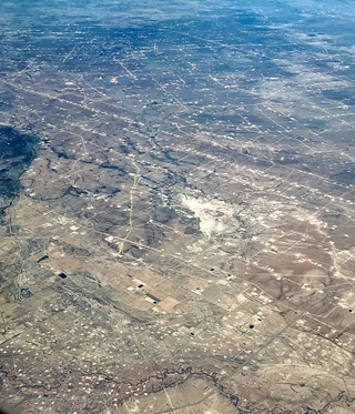 Aerial view of oil production facilities and fields in Ward County, West Texas