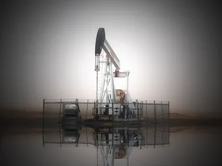 Pumpjack at dawn on a foggy morning at an Oklahoma oil and gas wellsite near Duncan in the Anadarko Basin region.