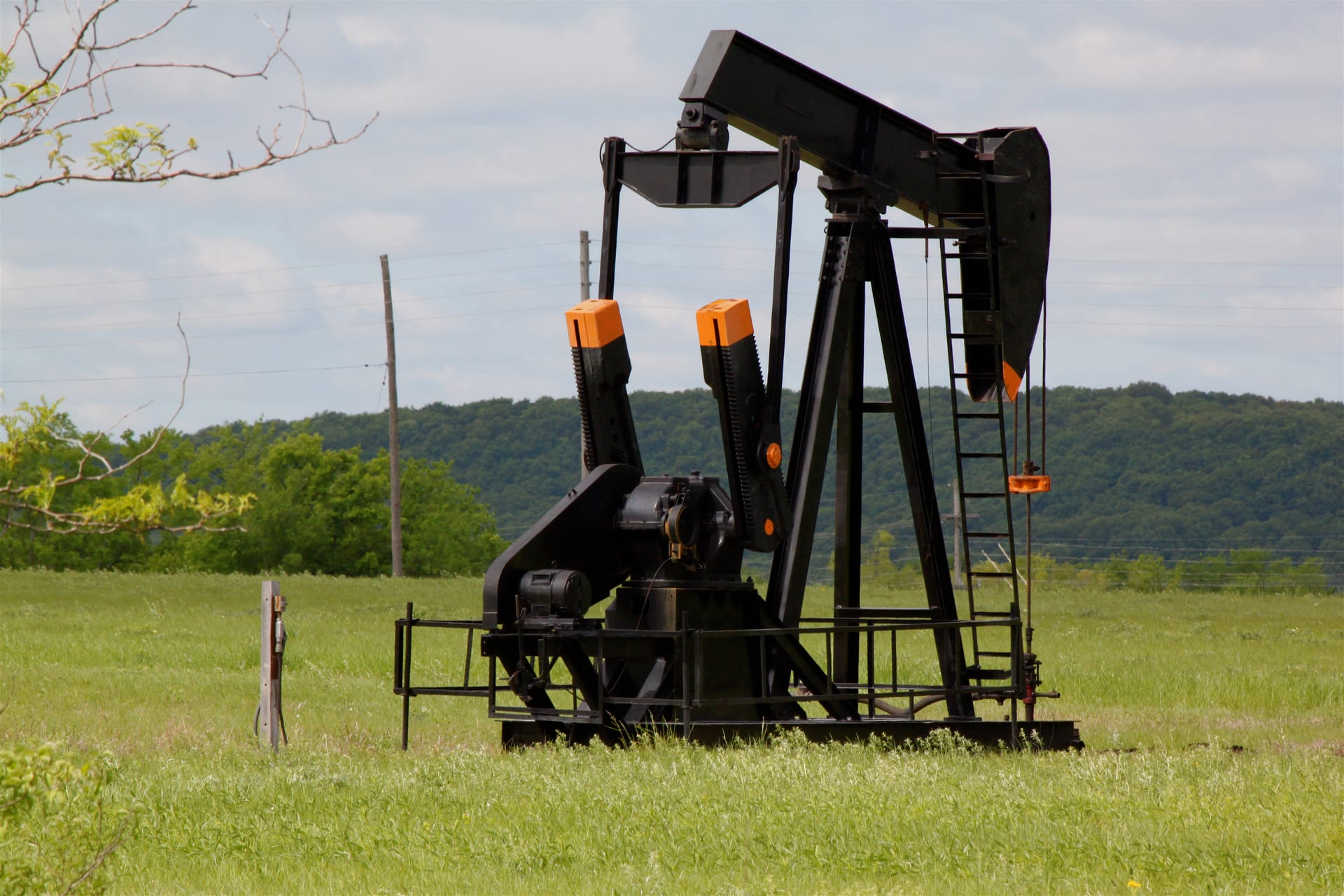 Oil pumpjack extracting crude oil at Glenn Pool oil field in Glenpool Oklahoma United States