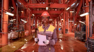 Eni SpA energy operations worker on offshore gas vessel deck in global operations