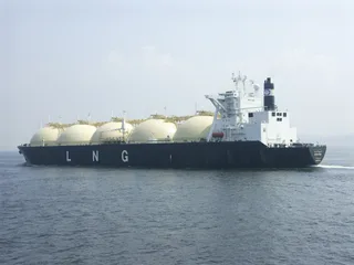 LNG carrier vessel with spherical cargo tanks sailing at sea loaded for delivery to terminals