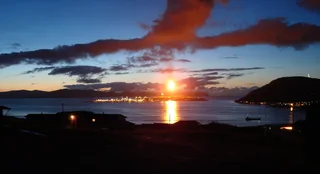 Hammerfest LNG plant on Melkøya island in Norway at dusk with gas flare