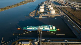 Aerial view of Golden Pass LNG export terminal with LNG carrier docked at Sabine Pass, Texas