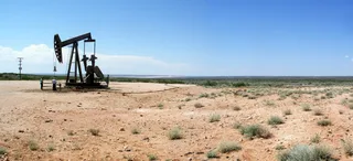 Petroleum extraction at an oil well in the Chihuahuan Desert of New Mexico, with pump jack and production equipment