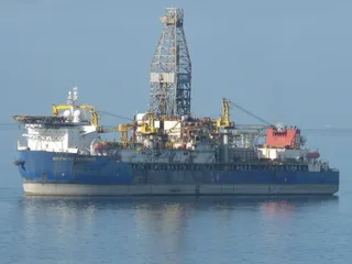 Transocean Deepwater Pathfinder drillship at sea in daylight with drill derrick visible