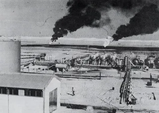Aerial view of a Libyan crude oil production facility showing storage tanks and oilfield infrastructure, photographed in 1973