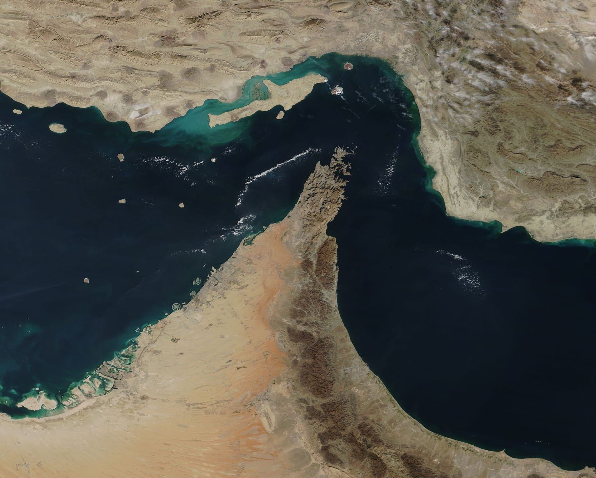 MODIS satellite image of the Strait of Hormuz showing the narrow chokepoint between Iran and the UAE Musandam Peninsula carrying 20 million barrels per day of global crude trade