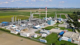 Natural gas processing facility with industrial towers and equipment at outdoor plant