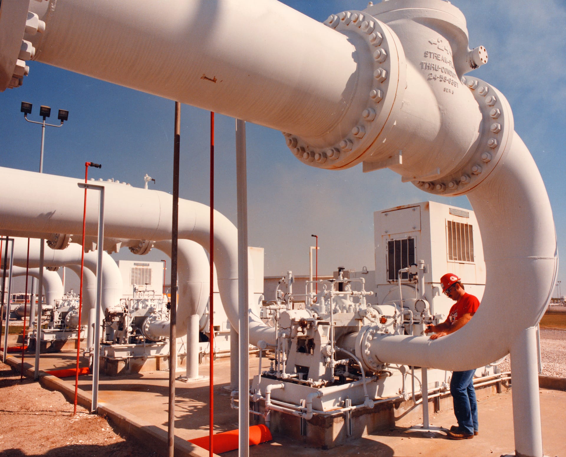 federal technician inspecting crude oil transfer pipe at the US Strategic Petroleum Reserve facility