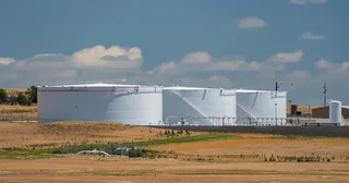 Suncor Energy crude oil storage tank farm in Wyoming with rows of large white storage tanks