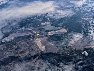 Aerial view of Syncrude Mildred Lake oil sands mining facility with tailings dam and sulfur stockpiles in Alberta