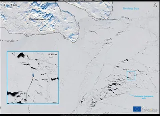 Russian icebreaking LNG carrier crossing the Arctic route through the Bering Strait