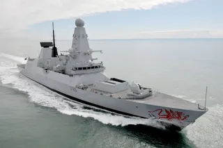 Royal Navy Type 45 air defence destroyer HMS Dragon underway in coastal waters showing her distinctive red Welsh dragon bow markings