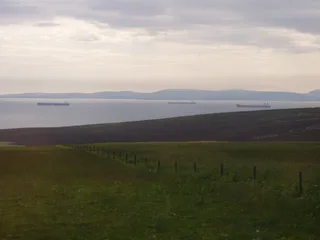 Multiple petroleum tankers waiting at anchor in calm waters, Scapa Flow Orkney Islands