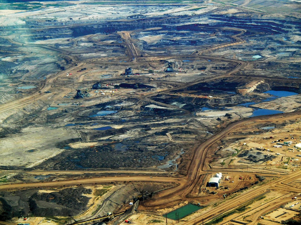 Exposed bituminous oil sands along river bank in Athabasca region of northern Alberta Canada