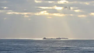 Large oil tanker vessel approaching Durban Harbour in South Africa at sunrise