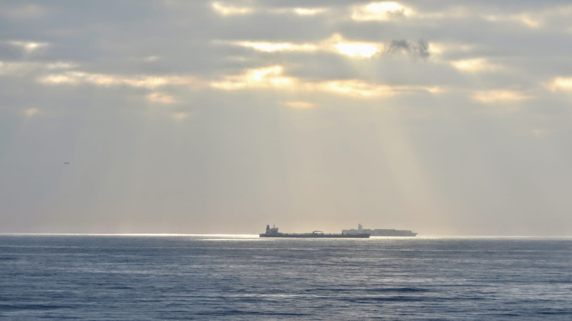 Large oil tanker vessel approaching Durban Harbour in South Africa at sunrise