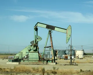 Pump jack mechanical lift device raising crude oil from a subsurface oil well