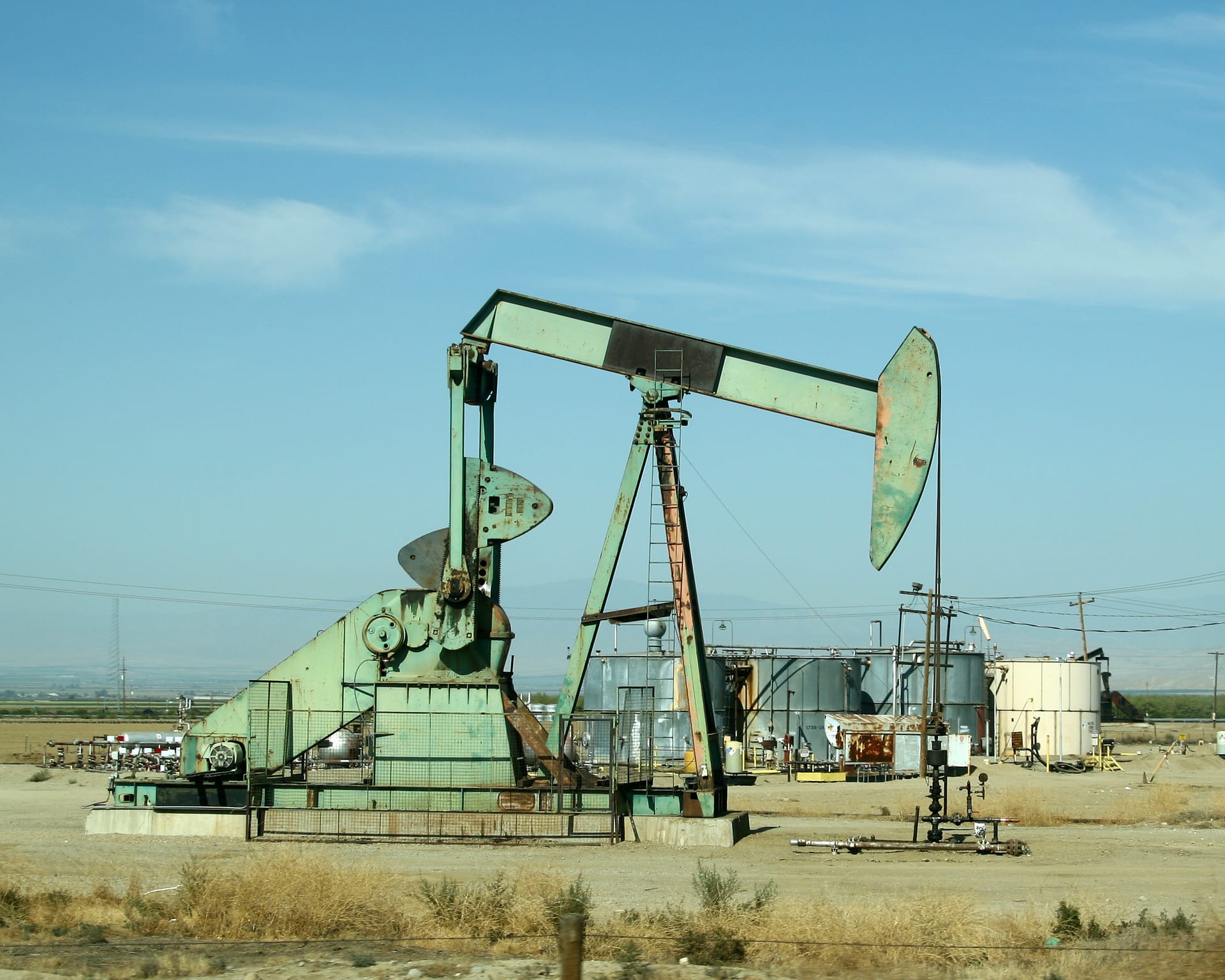 Pump jack mechanical lift device raising crude oil from a subsurface oil well